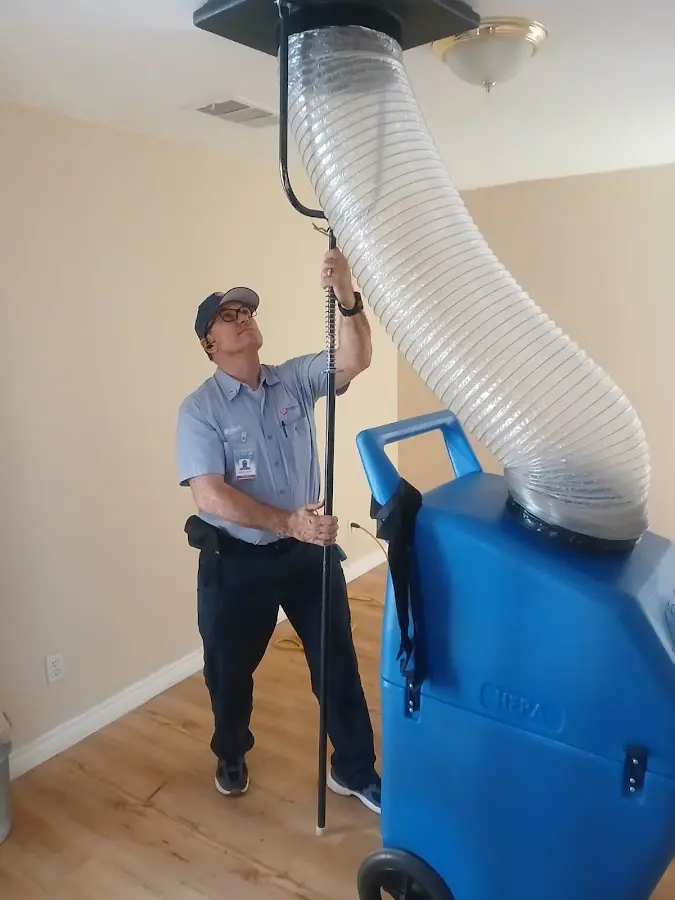 Furnace Tune-Up technician using HEPA equipment in Brooklyn Park